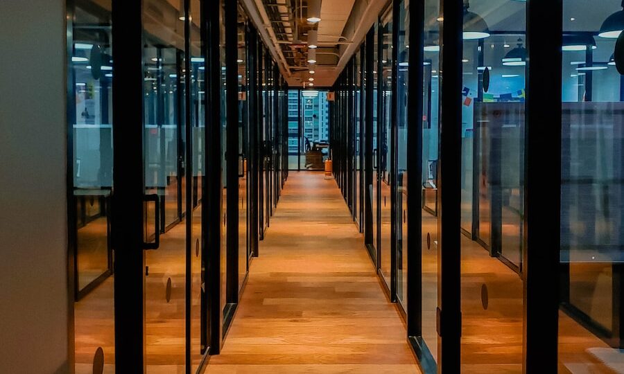 glass paneled long wooden floored hallway